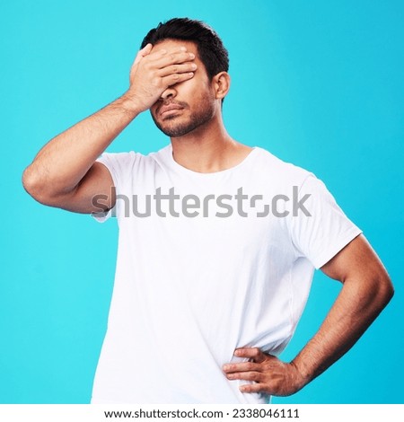Man, face palm and mistake in studio with thinking, regret and anxiety for fail by blue background. Young guy, student and cover eyes with stress, memory and shame for bad decision with depression