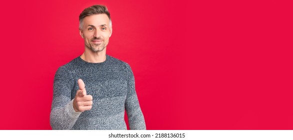 Man Face Portrait, Banner With Copy Space. Smiling Man In Sweater Point Finger On Red Background, Lifestyle.