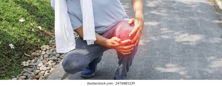 Man falling down and getting knee hurt from walking or jogging exercise at the park. pain and injury for elderly insurance concept.