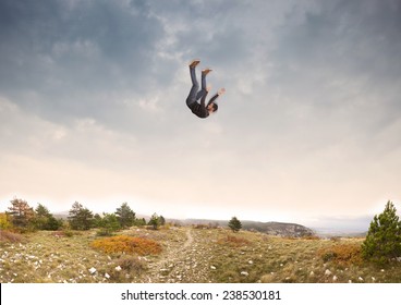 man falling down from the sky in autumnal landscape