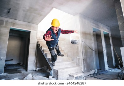 Man falling down the stairs. Accident of a man worker at the construction site. Work injury, accident in workplace.