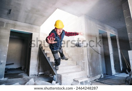 Man falling down the stairs. Accident of a man worker at the construction site. Work injury, accident in workplace.