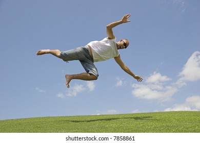 Man falling into the grass of a meadow
