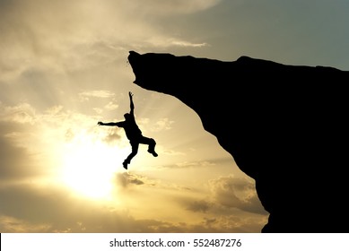 Man falling from the mountain edge. Conceptual scene. - Powered by Shutterstock