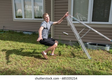 Man Falling Off A Ladder Outdoors.