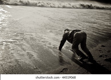 A Man Falls Into The Ocean And Struggles To Get Up