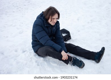 A Man Falls In The Snow. The Man Slipped And Was Injured. Falling On Slippery Ice. Winter. Fracture, Bruise, Dislocation.