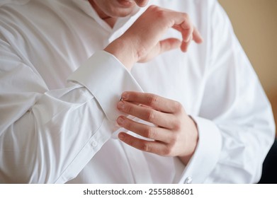 Man Fastening Cufflinks on a Stylish White Shirt Sleeve - Powered by Shutterstock