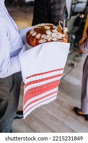 A Man, A Father, Holds A Round Loaf Decorated With Flowers, A Swan With An Embroidered Towel In His Hands. Close-up Wedding Food Photography, Traditions.