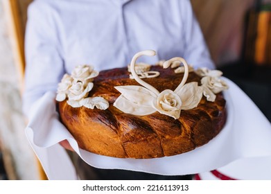 A Man, A Father, Holds A Round Loaf Decorated With Flowers, A Swan With An Embroidered Towel In His Hands. Wedding Food Photography.