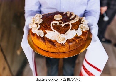 A Man, A Father, Holds A Round Loaf Decorated With Flowers, A Swan With An Embroidered Towel In His Hands. Wedding Food Photography.