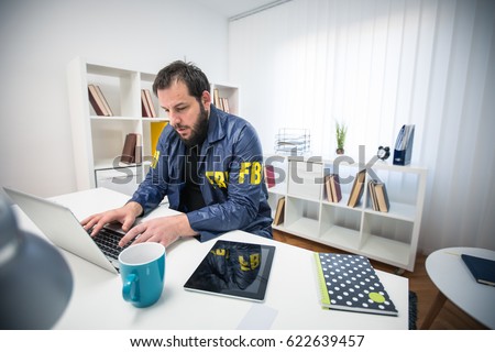 Man FBI agent working in his office on computer 