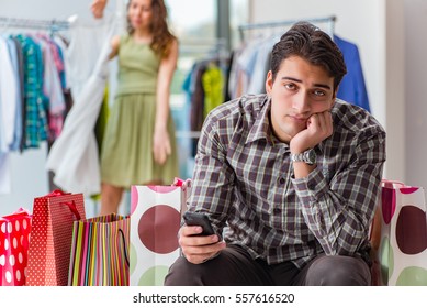 Man Fed Up With Wife Shopping In Shop