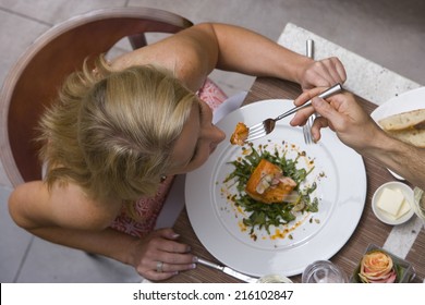 Man Feeding Woman At Dinner Table, Overhead View