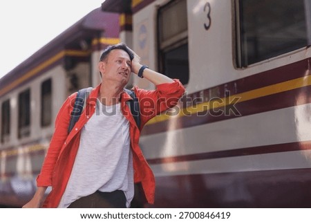 Man feeling frustrated and overwhelmed, missing connection at a train station