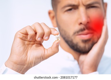 Man feeling pain after tooth extraction or tooth removal surgery - Shutterstock ID 2081017177