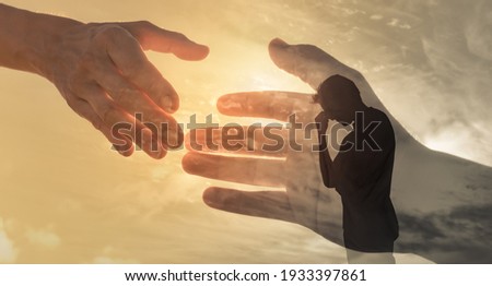 Man feeling sad and someone giving him a helping hand. Out of the darkness and into the light concept. 