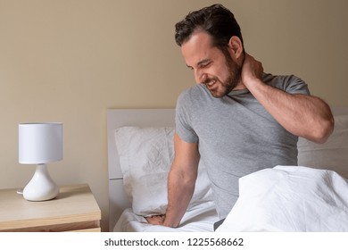 Man Feeling Stiff Neck After Sleeping In Bed