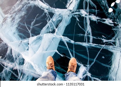 Man Feet In Boots On The Baikal Ice