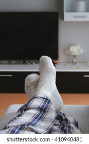 Man Feet In Front Of The Tv At Home