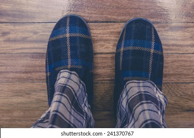 Man Feet At Home In Pajamas And Winter Slippers