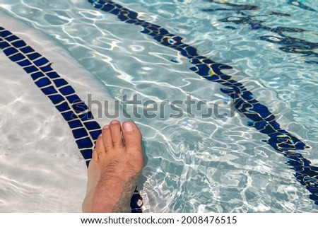 A man feet in the water