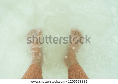 Man feets in lagoon