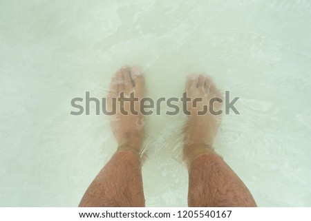 Man feets in lagoon