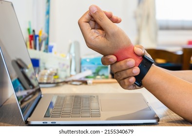 Man Felt His Wrist Hurt While Woking With Laptop At Home.