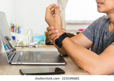 Man Felt His Wrist Hurt While Woking With Laptop At Home.