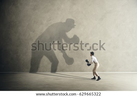 man fighting with his shadow, facing fears