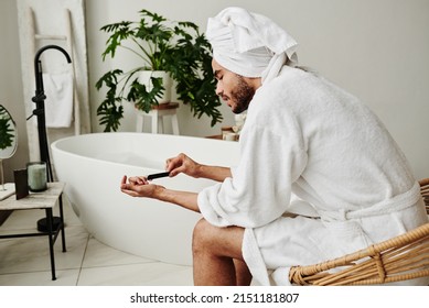 Man Filing Nails With A Nail File