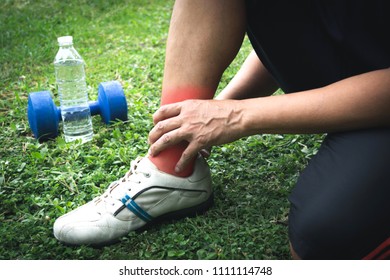 The man fill ankle or calf pain when he running exercise in a day time for sport, health concept.