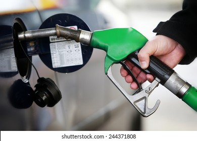 A Man Filling A Car With Petrol