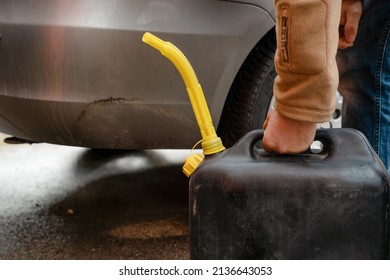 A Man Filling Fuel Tank Of His Car With Diesel Fuel From The Jerry Can As There Is No Fuel At The Petrol Station, Close Up