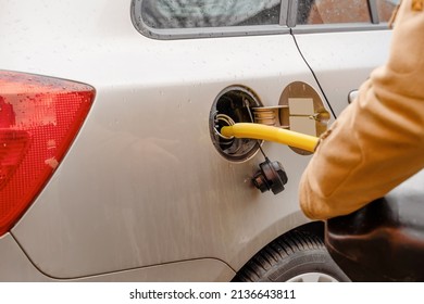 A Man Filling Fuel Tank Of His Car With Diesel Fuel Off The Jerry Can As There Is No Fuel At The Petrol Station, Close Up.