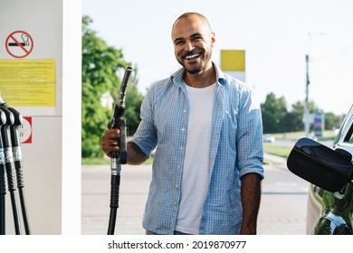 Man filling gasoline fuel in car at gas station - Shutterstock ID 2019870977