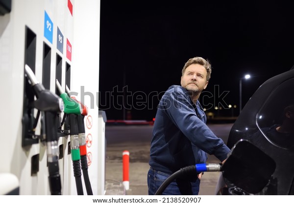 Man filling gasoline fuel in car. Hand refuelling
the car, pumping gasoline fuel in automobile at petrol station.
Gasoline, gas, oil.