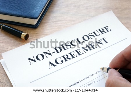 Man is filling in Non-Disclosure Agreement NDA.
