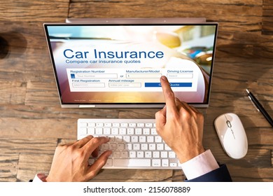 Man Filling Online Car Insurance Form On Laptop