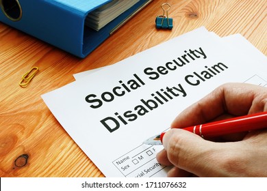 Man Filling In Social Security Disability Claim.