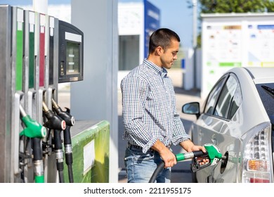 Man Filling Up Tank Of His Car With Gasoline In Gas Station