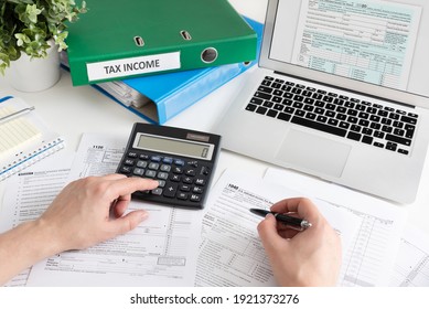 Man filling US tax form. US Individual income tax return. Accountant working with US tax forms - Shutterstock ID 1921373276
