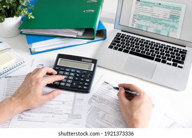 Man filling US tax form. US Individual income tax return. Accountant working with US tax forms