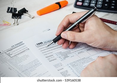 Man filling US tax form. tax form us business income office hand fill concept