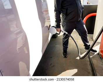 A Man Fills His Van Up With Gas.