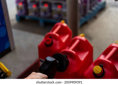 A man fills jerry cans at a gas station, Quebec, Canada.