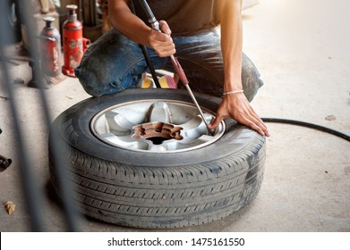 Man Fills Tire In Car, Tire Inflation And Proper Pressure Monitoring By Specialist Technicians,copy Space