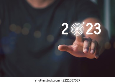 Man Finger pressing on start year 2023 button on virtual interface with copy space for text. Concept of new year. Beginning of New Year 2023. Year 2023 goal and target. - Shutterstock ID 2221087527