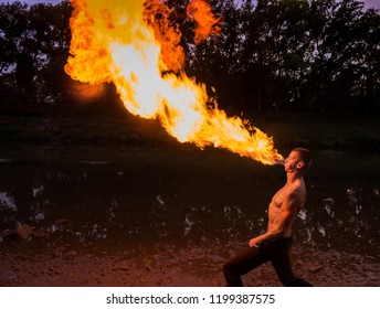  Man fire-eater blowing a large flame from his mouth - Powered by Shutterstock